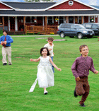 Photo of kids playing in the upper field at Jackson's Lodge and Log Cabins, Canaan, VT.