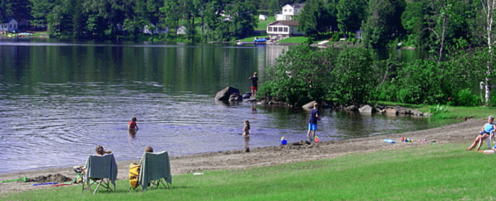 Photo of kids having fun playing on the sandy beach and in Wallace Pond (also known as Lake Wallace)