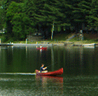 A guest at Jackson's Lodge fishes from a canoe on Lake Wallace (Click for larger image.)