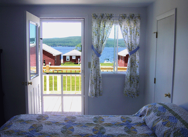 Our pet-free Wayfarer Room rentals open onto a deck overlooking the lake and cabins