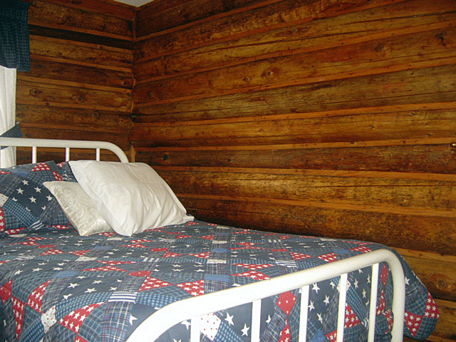 The interior of a bedroom in one of the original log cabins at Canaan, VT's Jackson's Lodge and Log Cabins