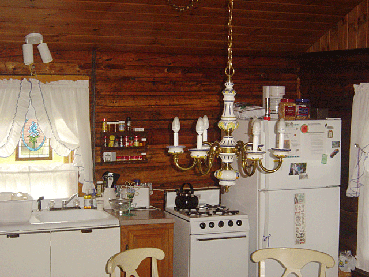 A fully equipped kitchen in one of the original log cabins at Jackson's Lodge and Log Cabins in Vermont Wildlife Management Unit E1