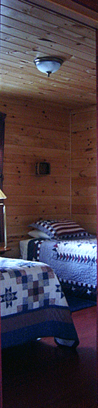 Knotty pine bedroom in one of Jackson's Lodge and Log Cabin rentals.