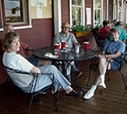 Family relaxing on the farmer's porch at the Main Lodge during a casual special occasion celebration (Click for larger image.)