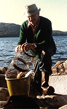 Elmont Jackson checks a minnow trap on Little Averill Lake, less than 10 miles from Lake Wallace.