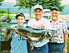 Three generations.  Father, son, and grandson from Chartierville, Quebec with trophy lake trout caught in the Connecticut Lakes in Pittsburg, NH, just a 20 minute drive from Jackson's. (Click for larger image.)