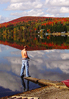 Fishing from the shore of Lake Wallace during foliage season