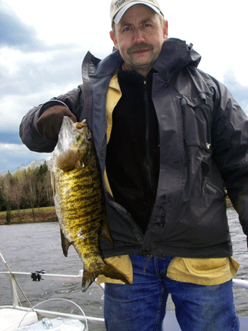 Photo of fisherman with huge bass taken from Wallace Pond (Lake Wallace) in Vermont's Northeast Kingdom