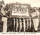 Two fishermen proudly display a sting of trout caught at the Marshall Camps (now Jackson's Lodge and Log Cabins) on Lake Wallace