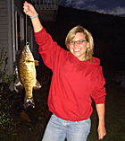 Photo of a happy girl with big smile after catching a nice fat bass from Wallace Pond (also known as Lake Wallace) during the VT Spring Catch-and-release Bass Season