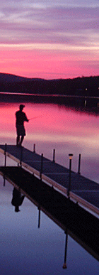 Photo of a fisherman enjoying a sunset on Wallace Pond (also known as Lake Wallace) during Vermont's Spring Fishing Catch-and-release Bass Season