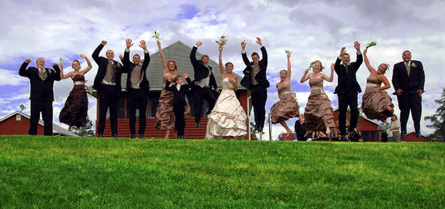 Wedding party jumps for joy at a Jackson's Lodge Vermont outdoor wedding - Sarah Sanville Photography