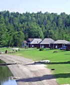 Looking down the eastern shore of Lake Wallace at Jackson's lakeside log cabins and Jackson's sandy beach (Click for larger image)