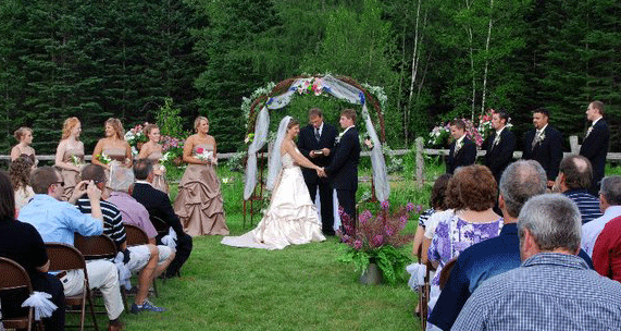 The bride and groom exchange vows at an outdoor wedding ceremony at Jackson's Lodge Sarah Sanville Photography - Click for larger image