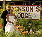 Newlyweds pose for wedding photos in part of   Jackson's Lodge main perennial garden - Don Whipple Photography - Click for larger image