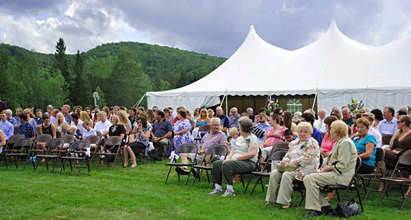 Guests await the bridal party at a Vermont outdoor tent wedding at Jackson's Lodge